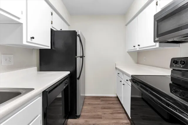a kitchen with a microwave and cabinets