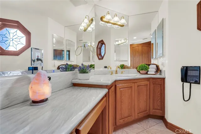 a spacious bathroom with a granite countertop sink and a mirror