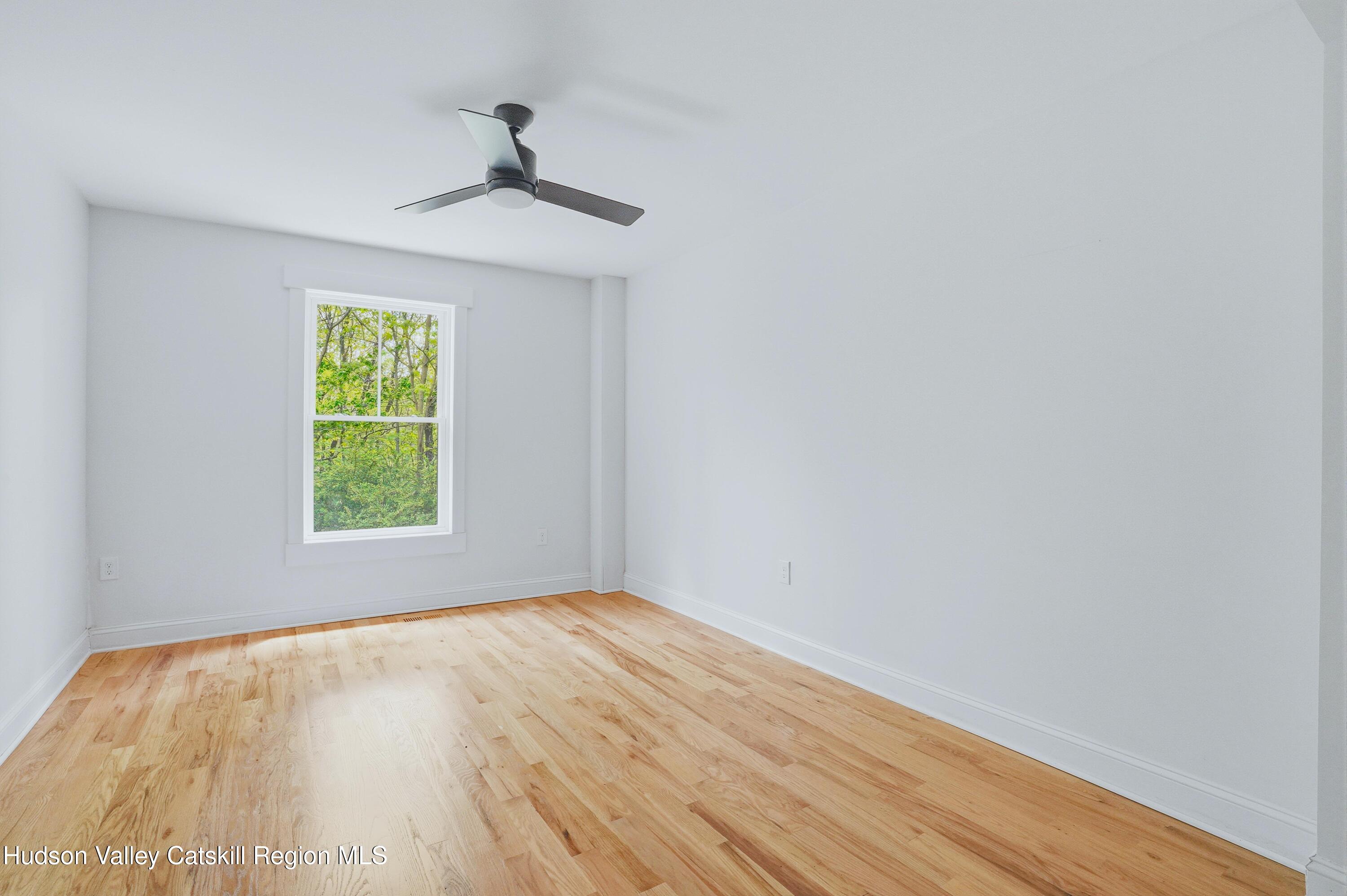 757 Taborton Road Sand Lake, NY 12153 - Photo 14 of 32 wooden floor in an empty room with a window
