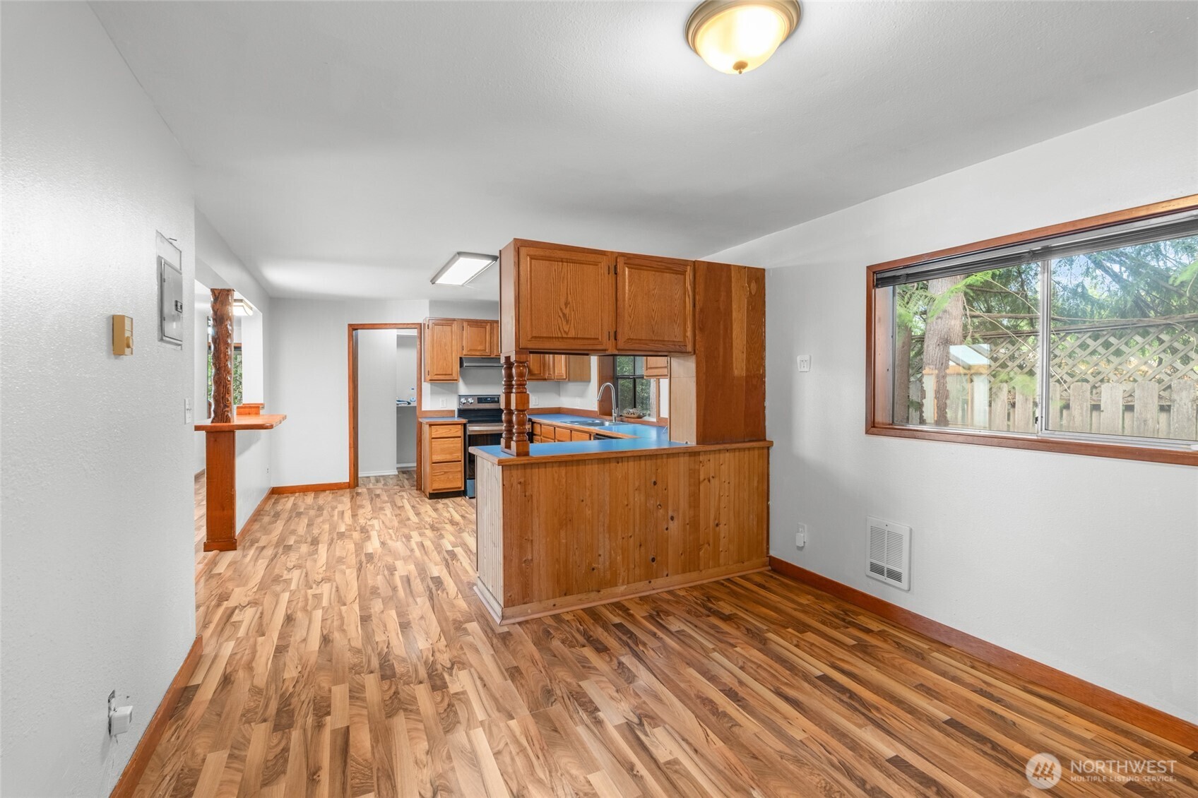 230 East Stavis Road Shelton, WA 98584 - Photo 12 of 35 a view of a living room hardwood floor and a kitchen with wooden floor