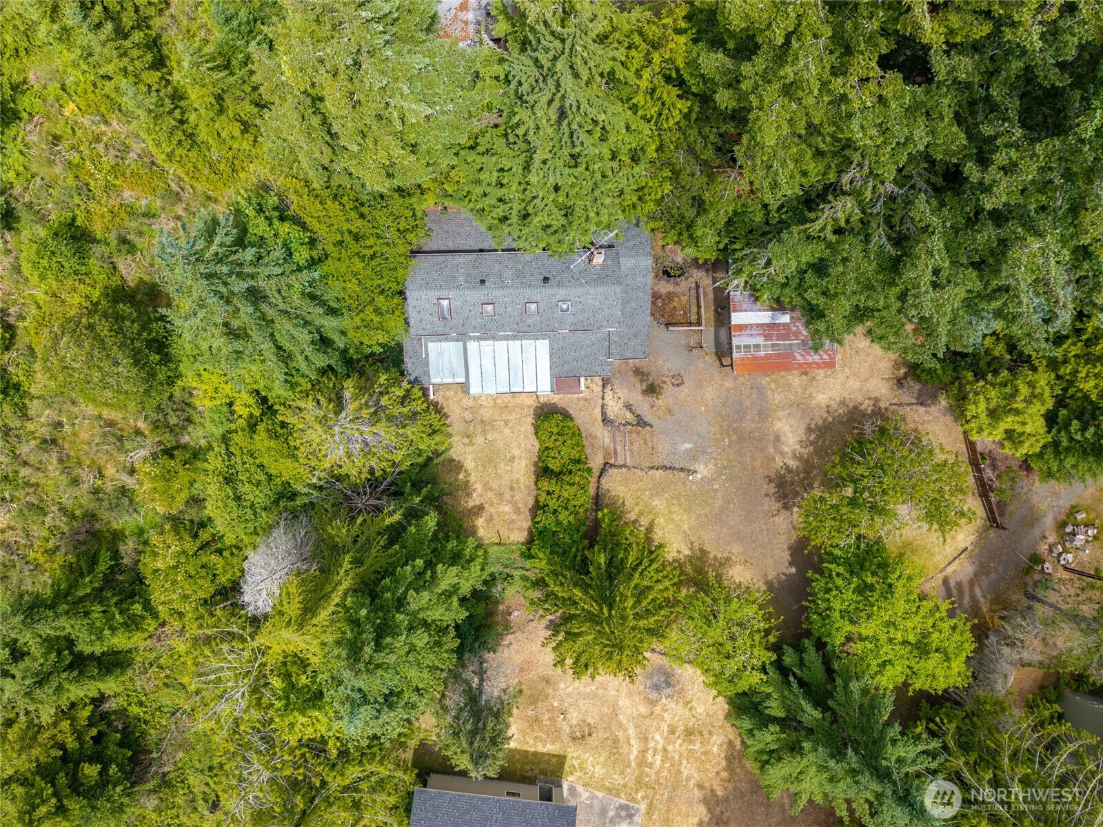 230 East Stavis Road Shelton, WA 98584 - Photo 29 of 35 a view of a house in a yard with plants and a large tree
