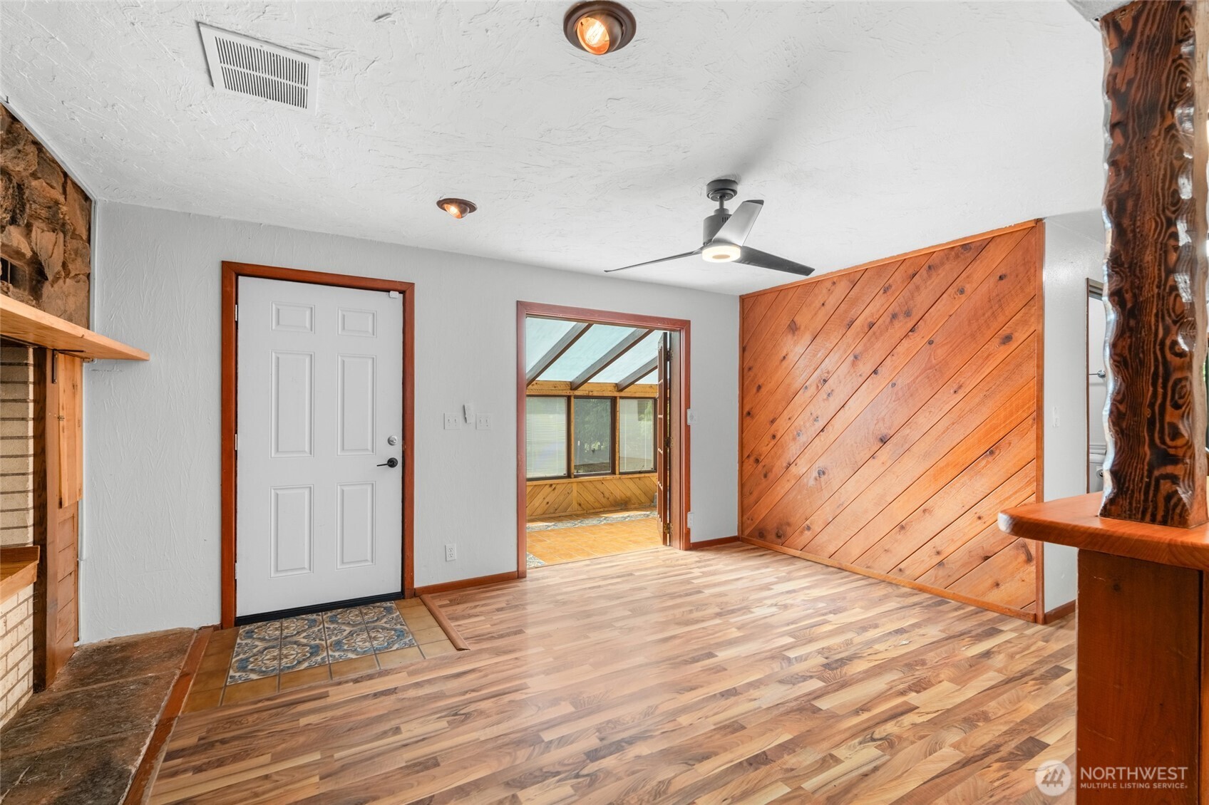 230 East Stavis Road Shelton, WA 98584 - Photo 4 of 35 a view of a livingroom with wooden floor and a ceiling fan