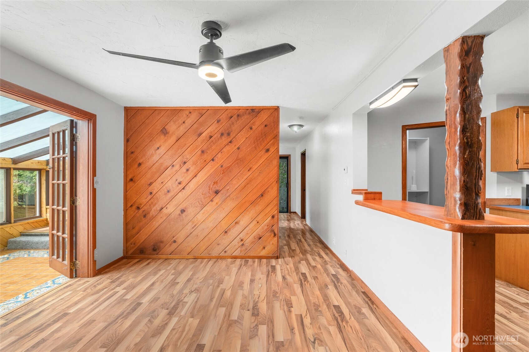 230 East Stavis Road Shelton, WA 98584 - Photo 5 of 35 a view of a hallway with wooden floor and a ceiling fan