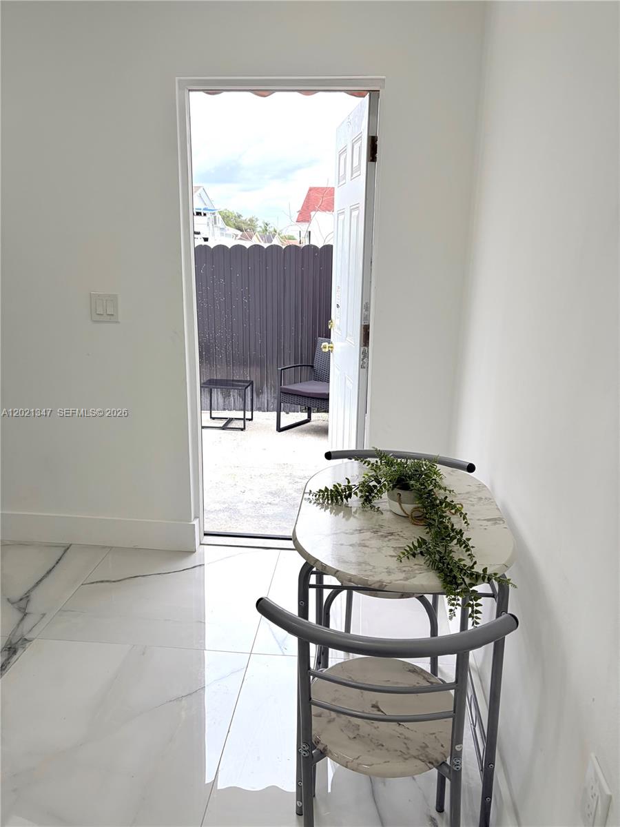 13065 Southwest 263rd Terrace, Unit 2 Homestead, FL 33032 - Photo 6 of 15 a table and chairs in a room
