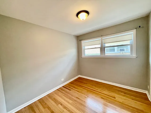 a view of a room with wooden floor and fan