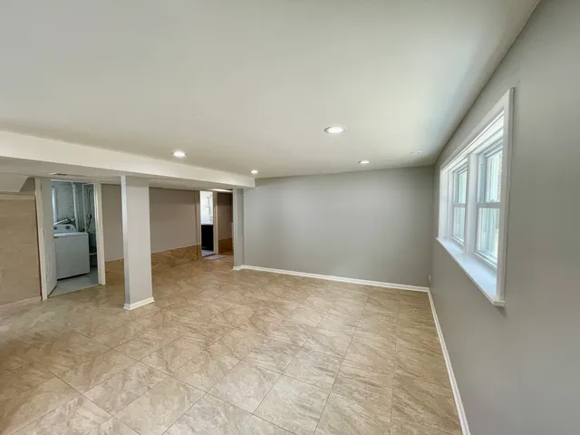 an empty room with windows and entrance