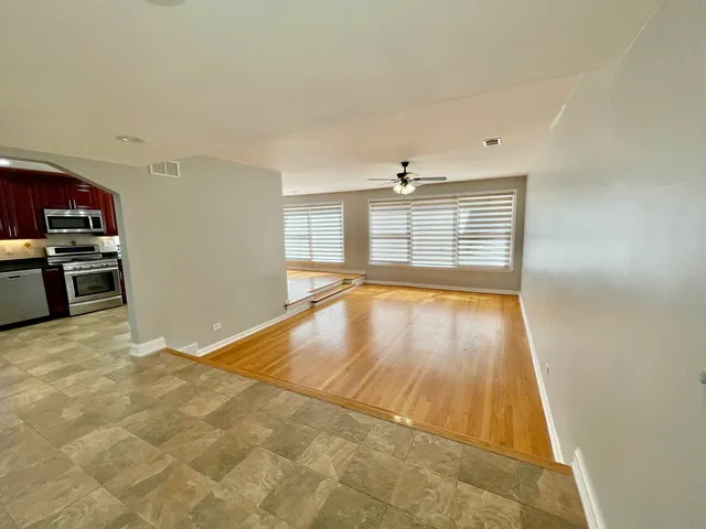 a view of a kitchen with wooden floor and a sink