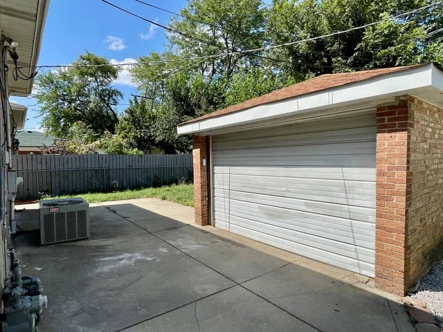a white house with tree in the background
