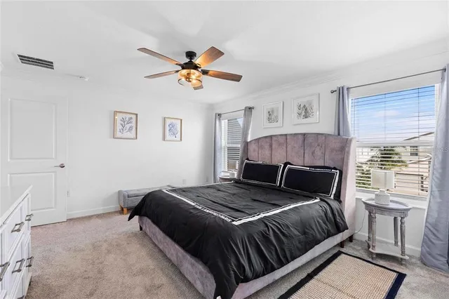 a bedroom with a large bed and a window