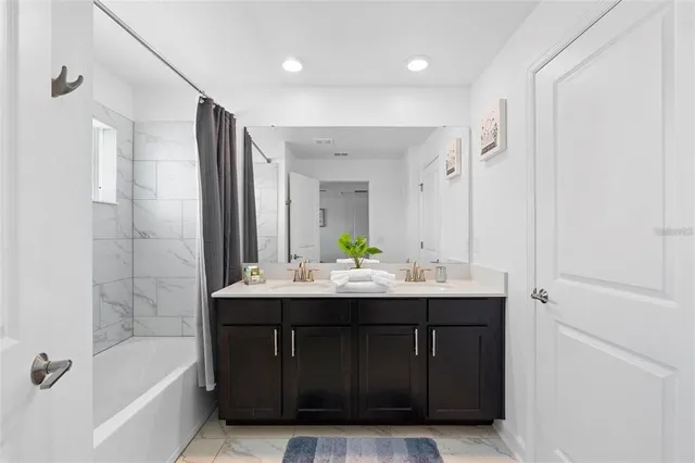 a bathroom with a bathtub and a sink