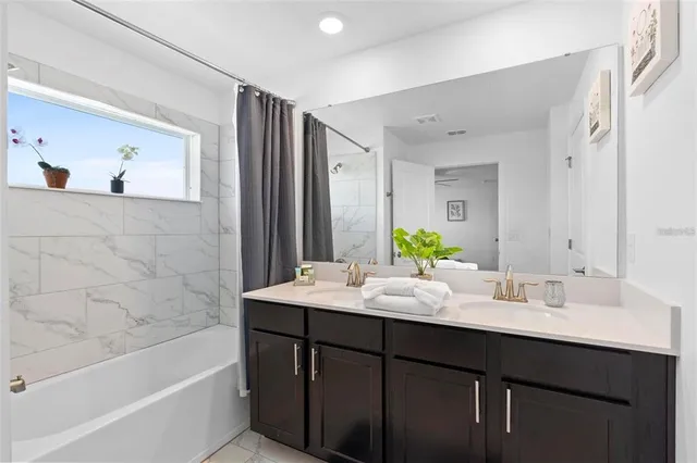 a bathroom with a tub sink and mirror