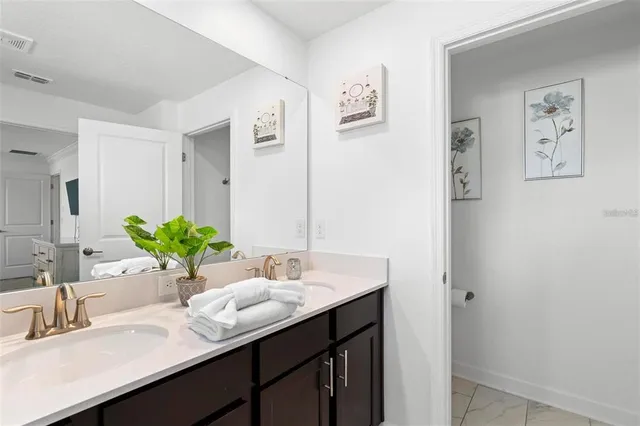 a bathroom with a sink a and a mirror
