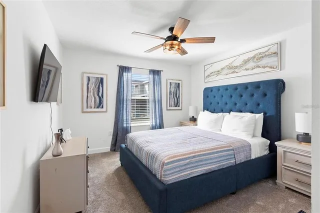 a bedroom with a large bed and a chandelier