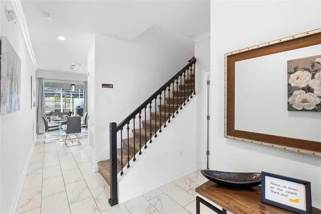 a view of a hallway with wooden floor and dining room