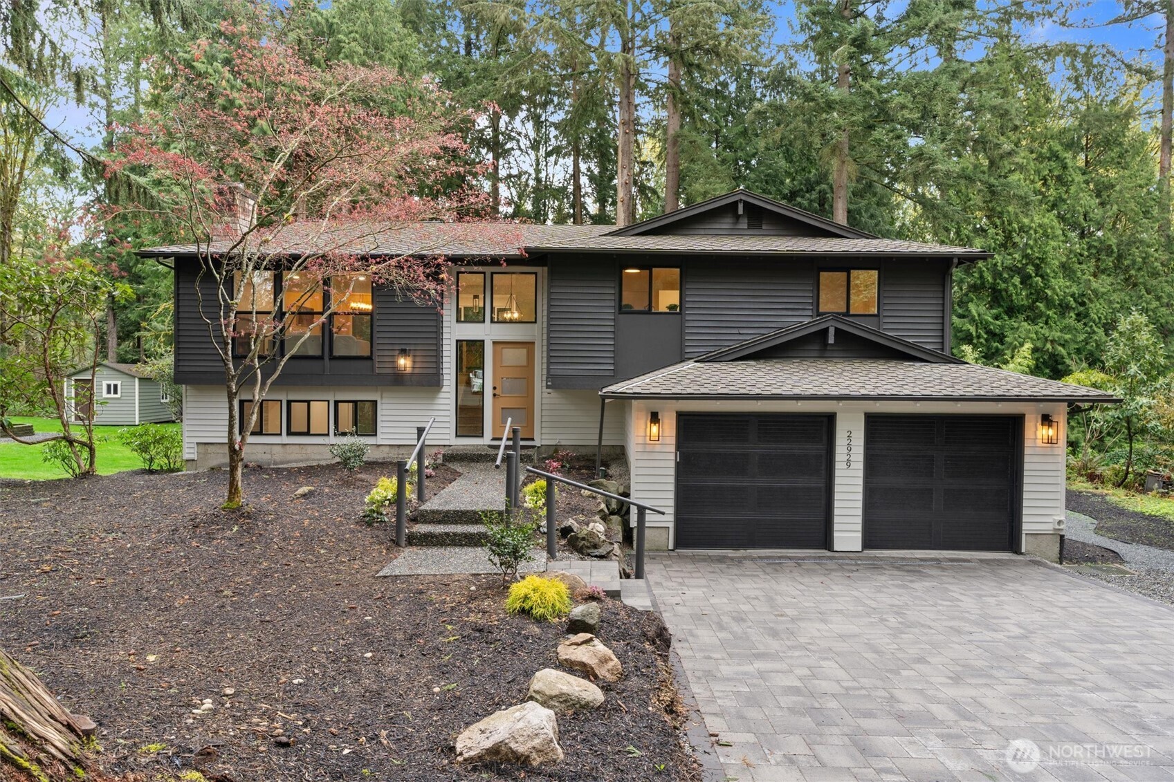 a front view of a house with a garden and porch