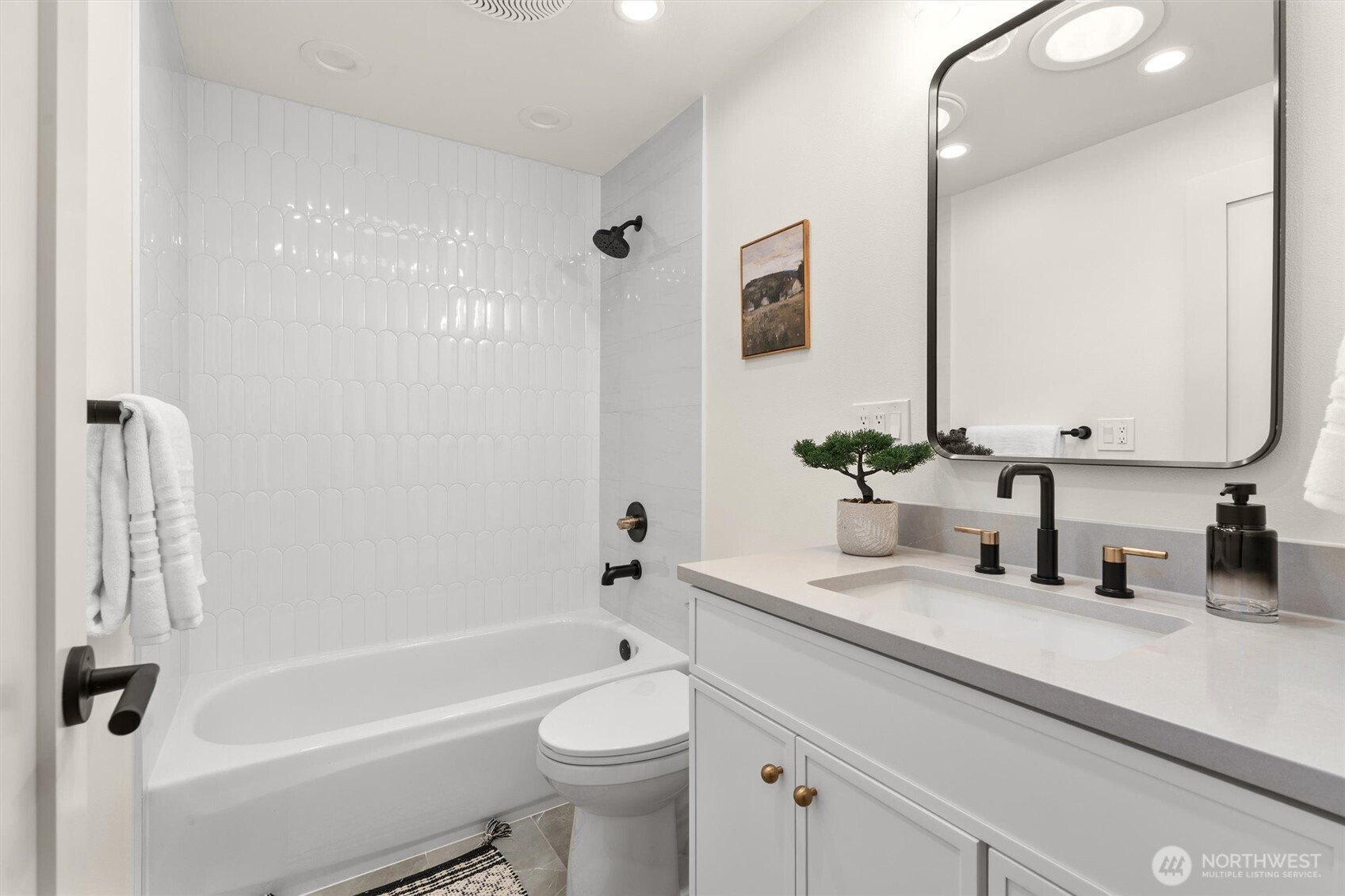 22929 38th Avenue Southeast Bothell, WA 98021 - Photo 23 of 37 a bathroom with a granite countertop sink a toilet a mirror a vanity a shower and bathtub