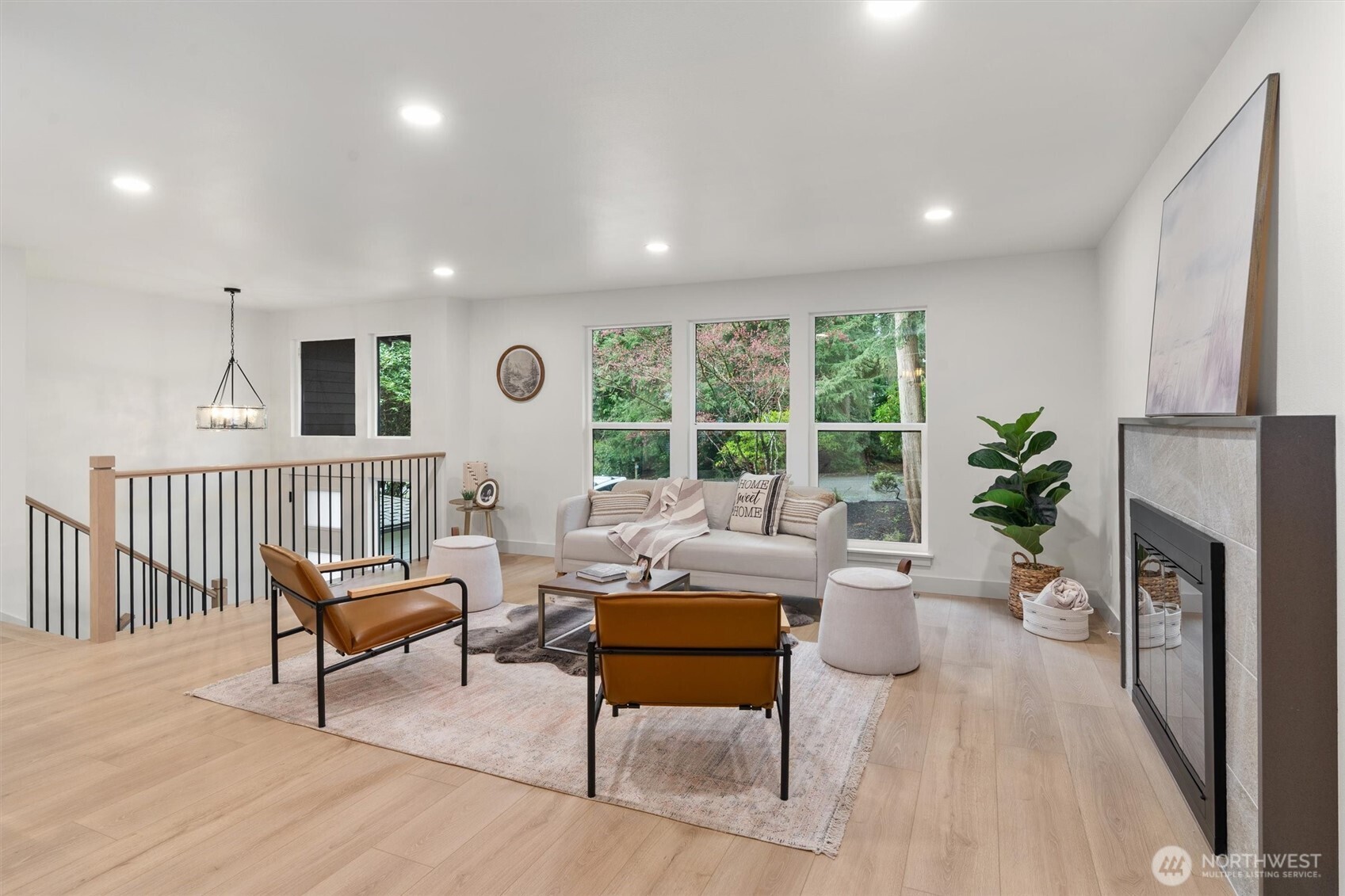 22929 38th Avenue Southeast Bothell, WA 98021 - Photo 4 of 37 a living room with furniture a fireplace and a large window