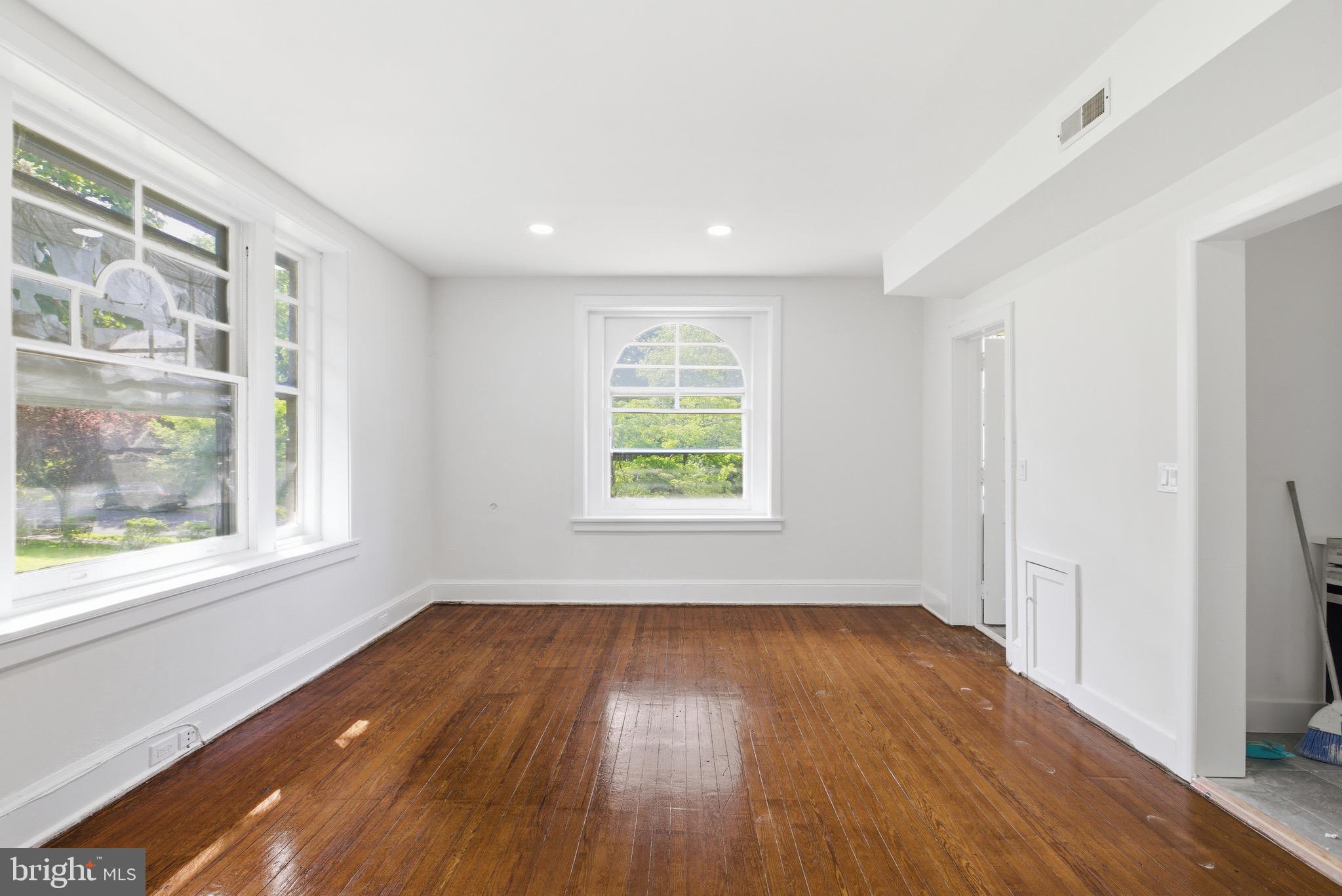 5939 Drexel Road, Unit 2 Philadelphia, PA 19131 - Photo 7 of 17 an empty room with wooden floor and windows