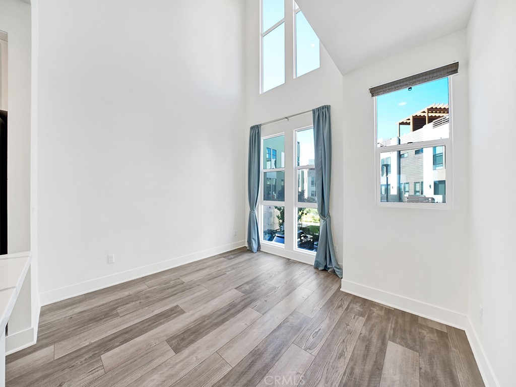 1658 Topanga Costa Mesa, CA 92627 - Photo 11 of 32 an empty room with wooden floor and windows