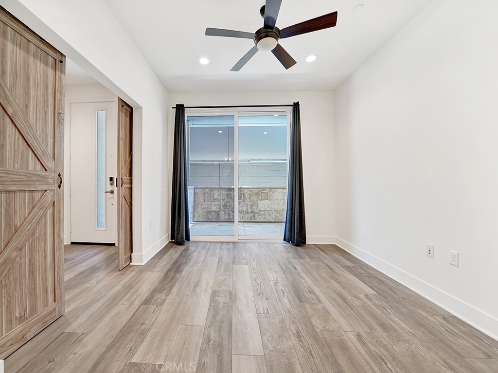 1658 Topanga Costa Mesa, CA 92627 - Photo 4 of 32 an empty room with wooden floor cabinet and windows