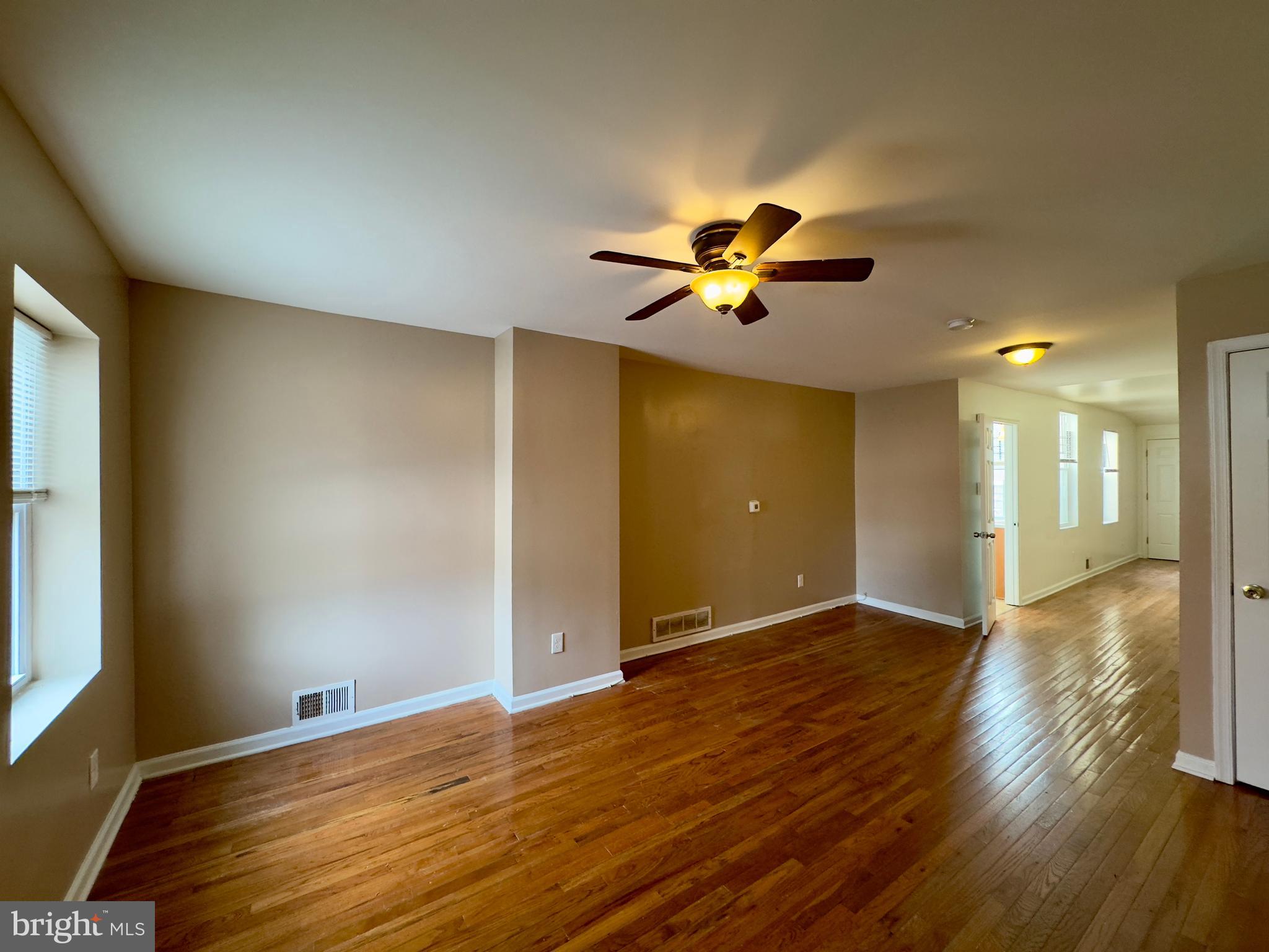 2033 Orleans Street Baltimore, MD 21231 - Photo 11 of 22 a view of a livingroom with a flat screen tv and wooden floor