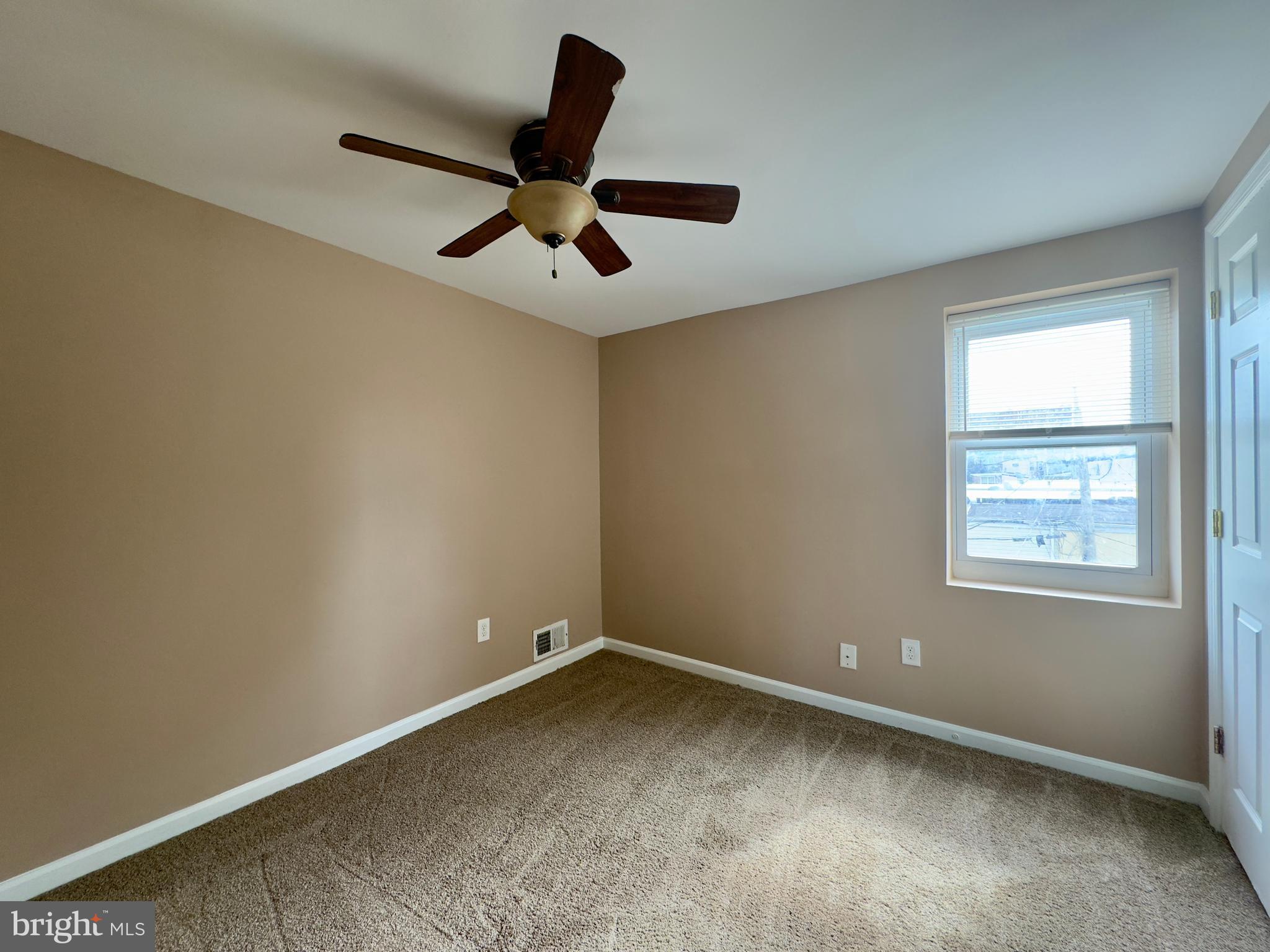 2033 Orleans Street Baltimore, MD 21231 - Photo 8 of 22 an empty room with a ceiling fan and windows