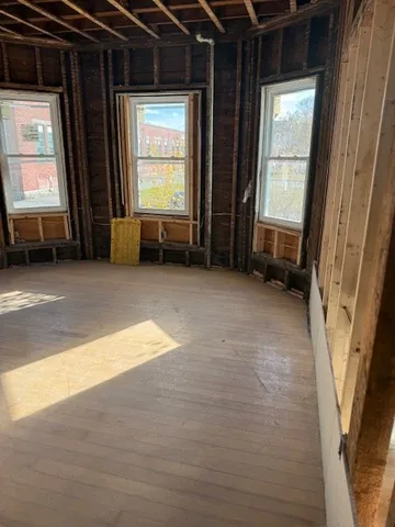 a view of room with window and a fireplace