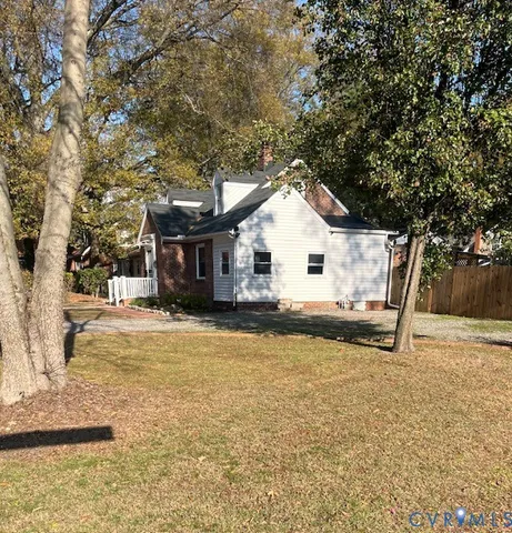 a view of a house with a yard and sitting area
