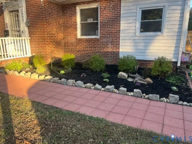 a backyard of a house with lots of green space and outdoor seating