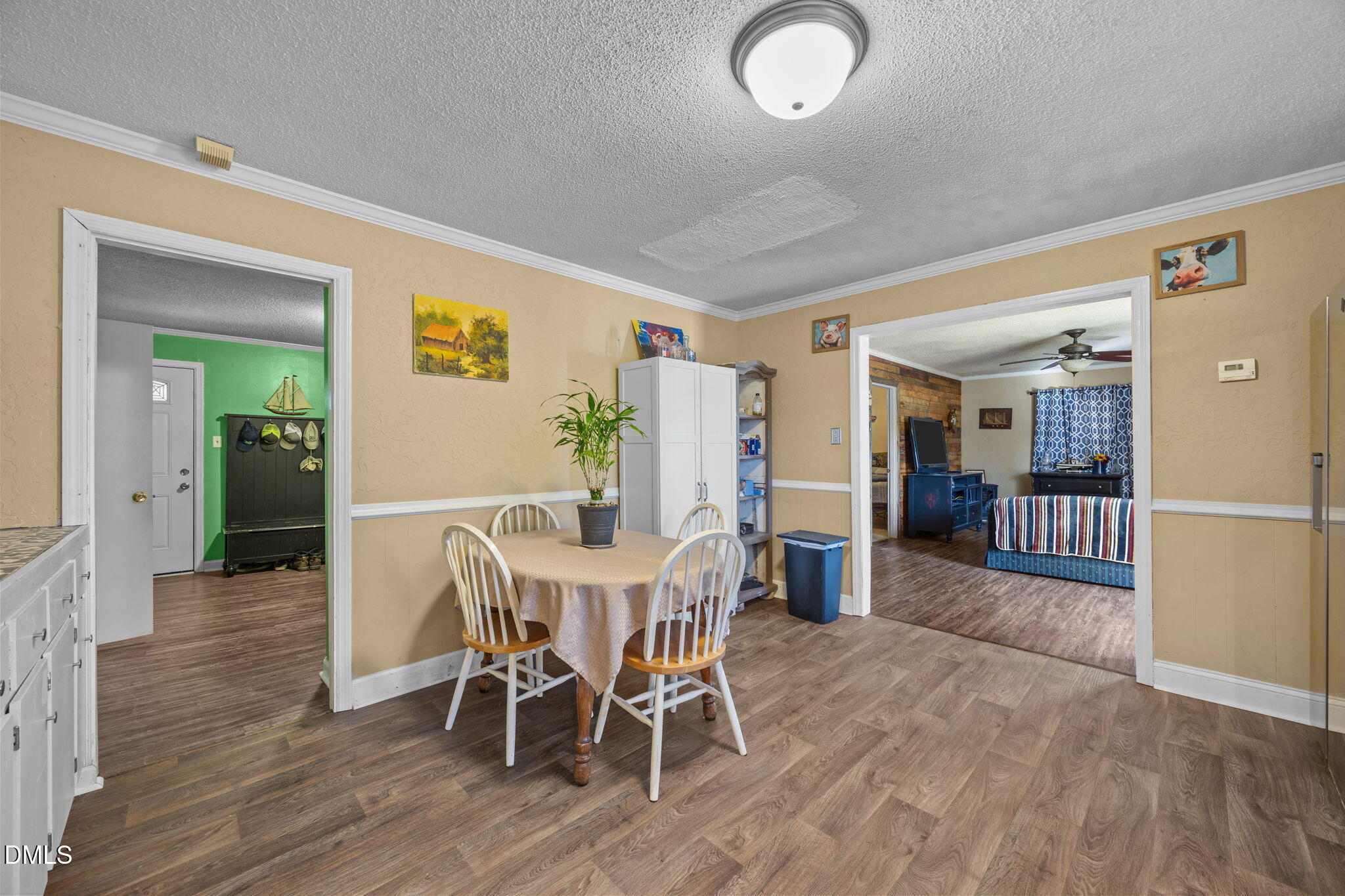 7840 Barbour Store Road Willow Spring, NC 27592 - Photo 7 of 20 a view of a dining room with furniture and wooden floor