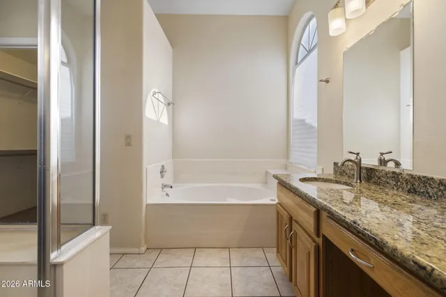 a bathroom with a granite countertop sink a toilet and bathtub