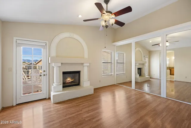 a view of an empty room with a fireplace and a window