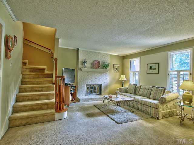 5600 Hamstead Crossing Raleigh, NC 27612 - Photo 3 of 25 Your separate living room has a wood burning fireplace with a brick mantle.