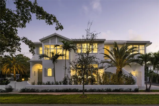a front view of a house with swimming pool and porch