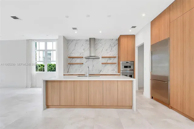 a kitchen with stainless steel appliances a refrigerator and a sink