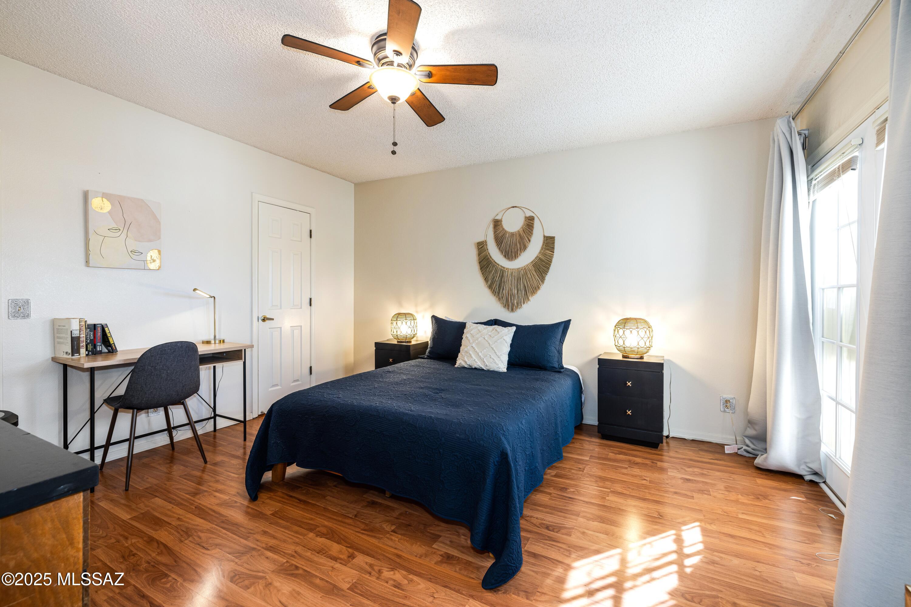 1200 East River Road, Unit G88 Tucson, AZ 85718 - Photo 6 of 13 a bedroom with a bed and a chandelier