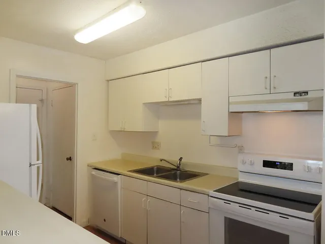 a kitchen with stainless steel appliances a sink stove and refrigerator