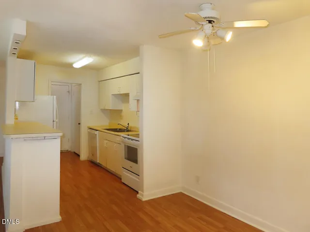 a kitchen with a refrigerator and a stove top oven