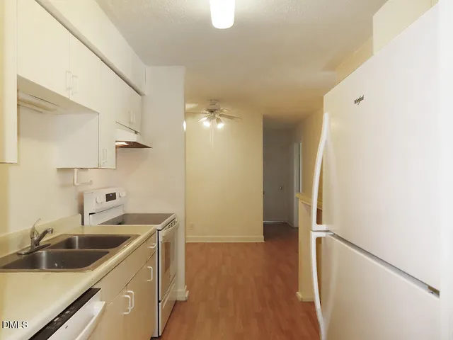 a kitchen with a sink and refrigerator