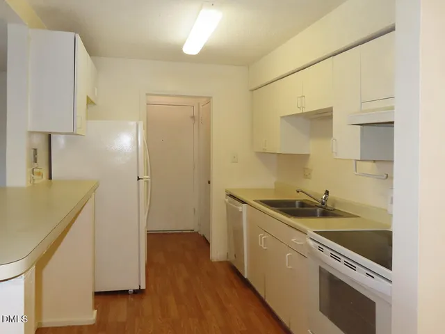 a kitchen with a sink and a refrigerator