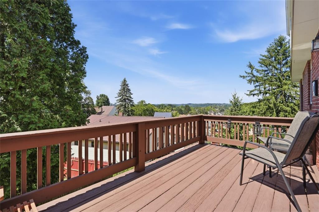 3941 Drexel Road Pittsburgh, PA 15212 - Photo 38 of 49 Enjoy the elevated rear deck, perfect for relaxing outdoors while taking in fresh air, green scenery, and open blue skies.