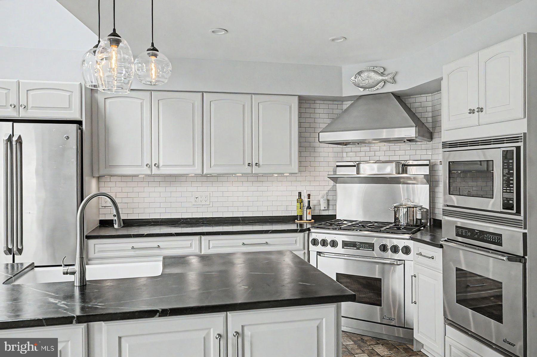4009 Smoke Road Doylestown, PA 18902 - Photo 7 of 52 a kitchen with kitchen island a sink stove and refrigerator