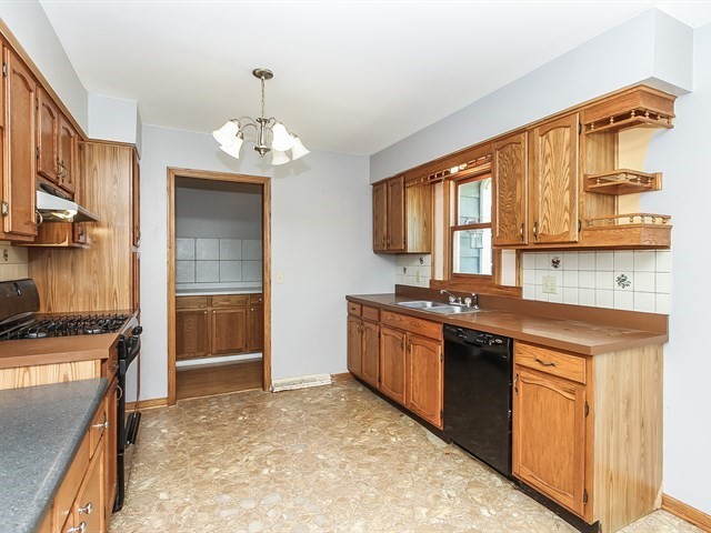 35W328 Ridge Road Dundee, IL 60102 - Photo 8 of 23 a kitchen with stainless steel appliances granite countertop a sink stove and refrigerator