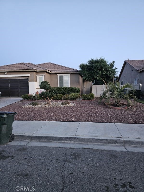 11847 Branch Court Adelanto, CA 92301 - Photo 1 of 18 a front view of a house with a yard and garage