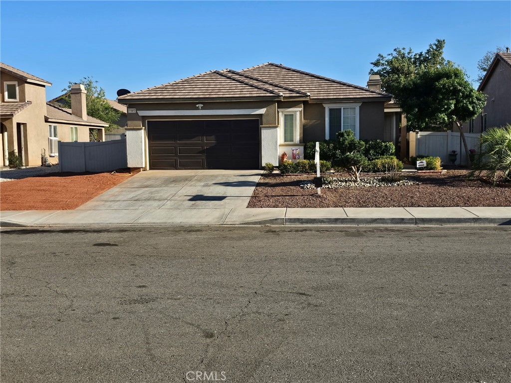 11847 Branch Court Adelanto, CA 92301 - Photo 18 of 18 a front view of a house with yard garage and outdoor seating
