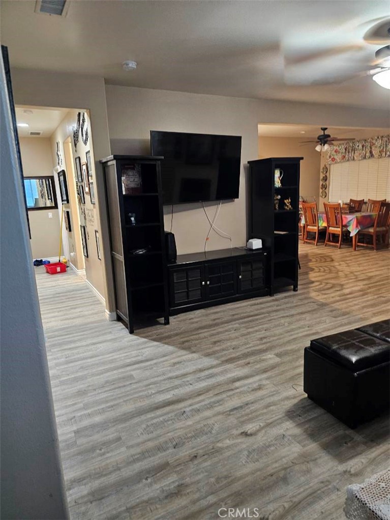 11847 Branch Court Adelanto, CA 92301 - Photo 2 of 18 a living room with furniture and a flat screen tv