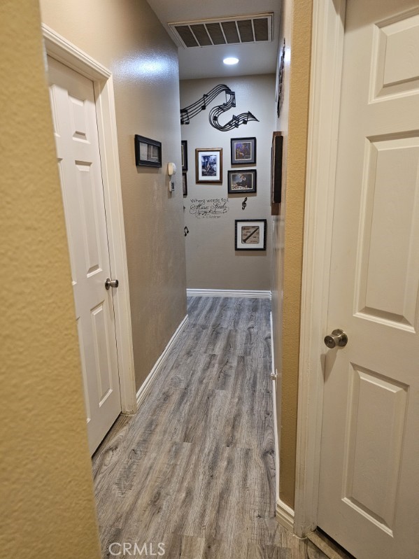 11847 Branch Court Adelanto, CA 92301 - Photo 5 of 18 a view of a hallway with wooden floor