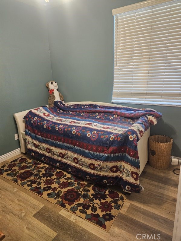 11847 Branch Court Adelanto, CA 92301 - Photo 8 of 18 a bed sitting in a bedroom next to a window