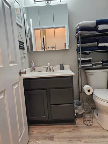 a bathroom with a sink toilet and mirror