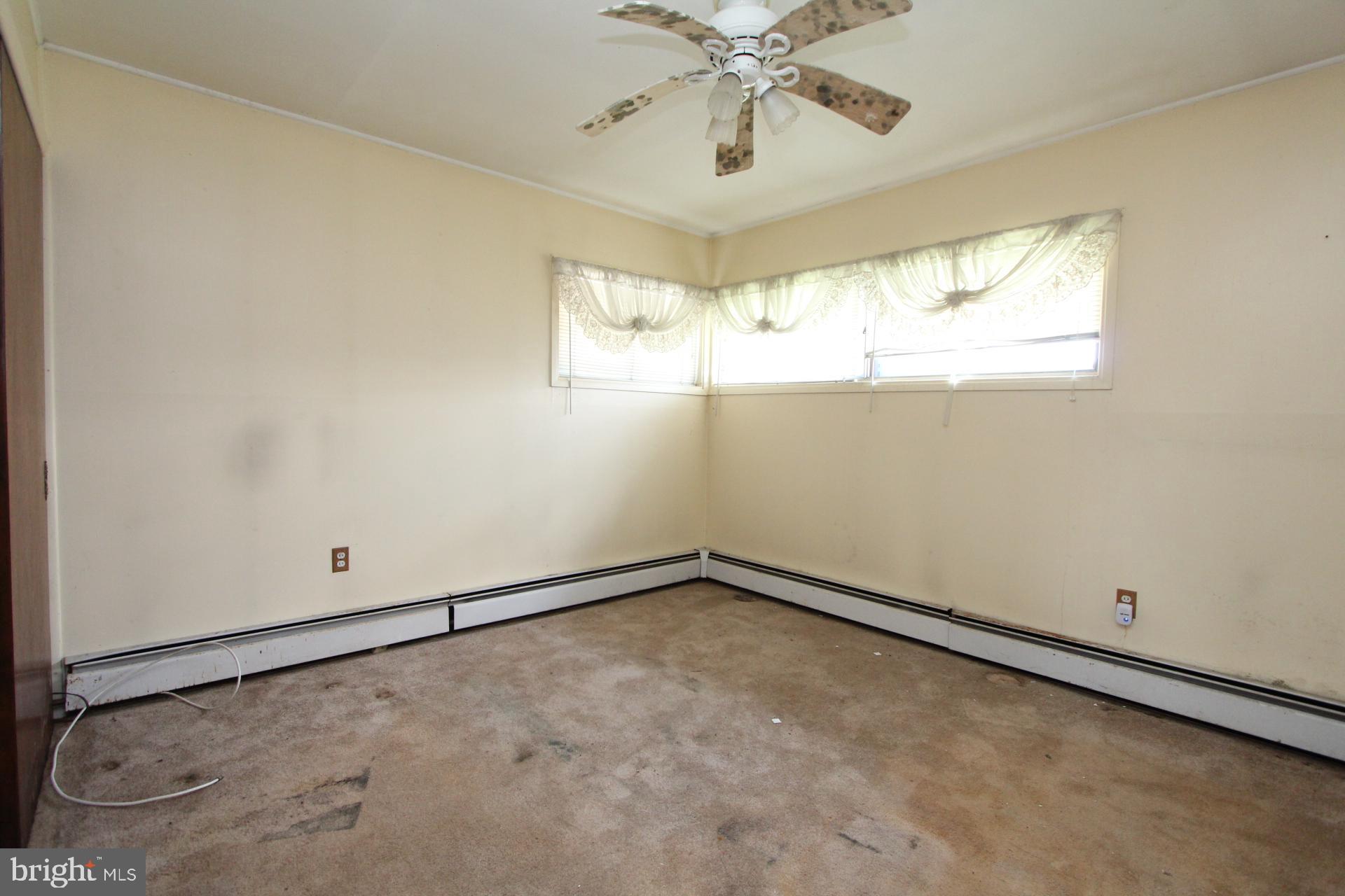 41 Jewel Lane Levittown, PA 19055 - Photo 16 of 24 an empty room with windows and chandelier fan